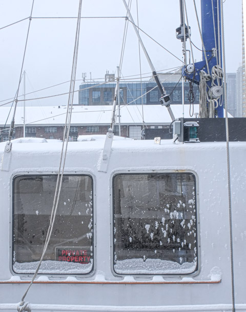 windows on a boat with snow on them, ropes, 