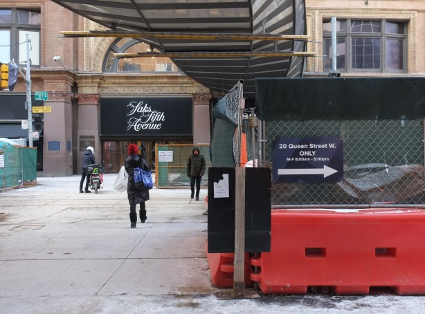 hoardings create a path across Queen street to provide access to Eaton Centre