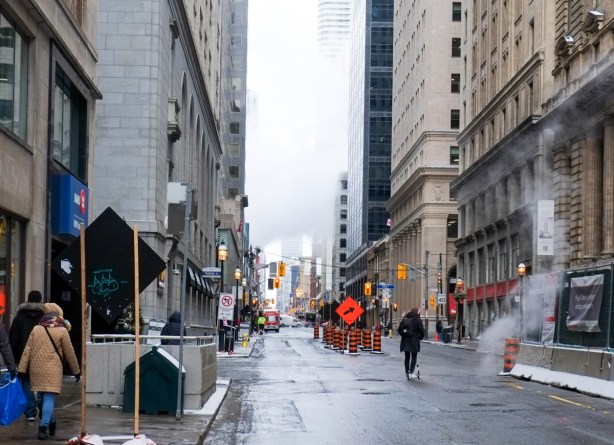 Yonge street looking north at king on a cold winter day, steam coming from manhole, steam and fog above the street too