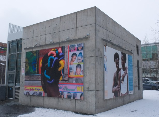 harbourfront parking pavilion and entrance building with two large photographs by Nigerian Stephen Tayo featuring black men, and black hair