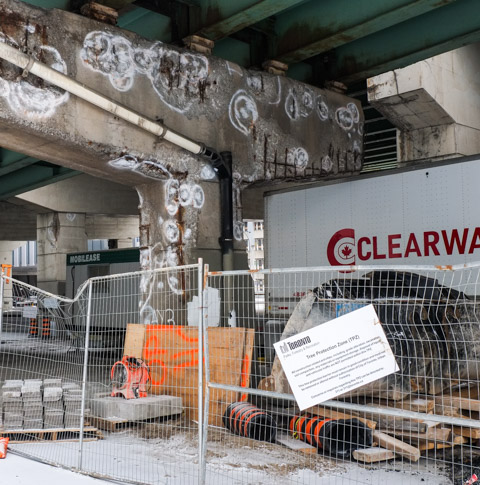 City of Toronto tree protection zone sign on a fence around a construction supply site. no trees there, under the Gardiner Expressway 