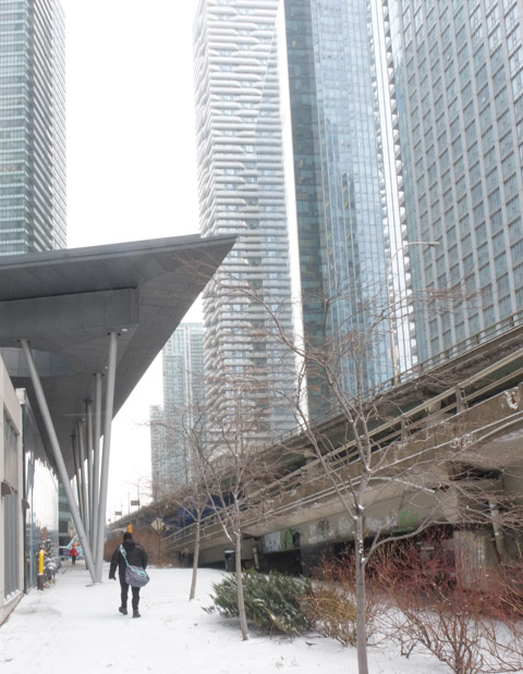 walking beside a Gardiner Expressway ramp, near York street, north side