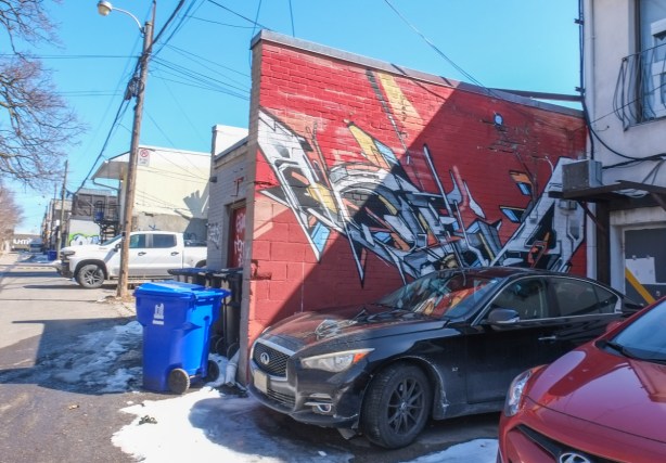 mural by mediah, geometric shapes, sharp angles, straight lines, on red background