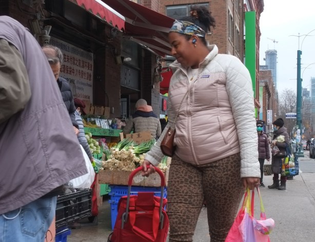 people buying fruit and vegetables from a market, on the sidewalk, 