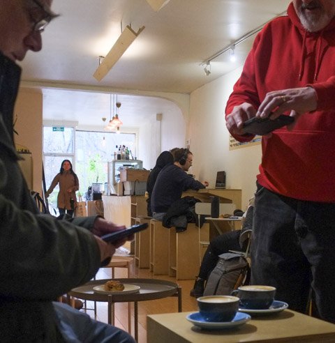 taking pictures of cups of flat white coffee in a coffee shop