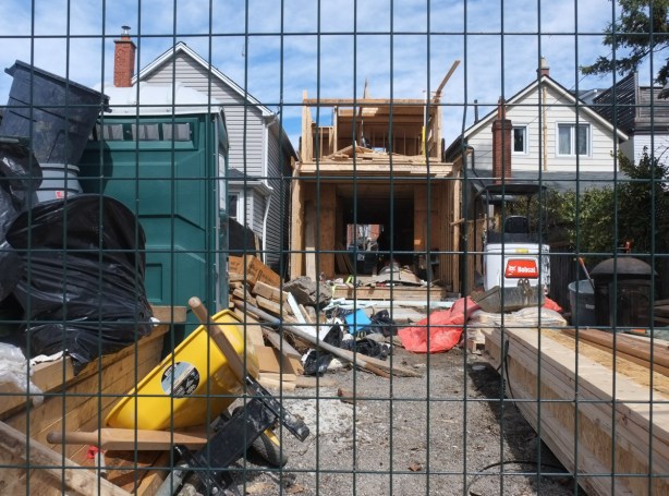 view from alley behind, most of interior of house has been gutted for a renovation