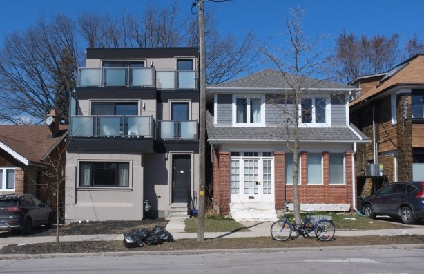 new three story residence beside an older house 