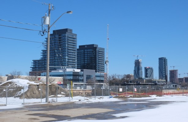 looking across vacant lot towards new condo development