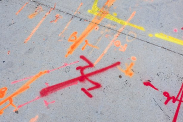 red, orange, and yellow markings on sidewalk, pre construction layouts and routing of underground systems