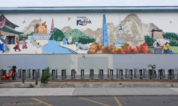 Imagine Your Korea mural in Koreatown, with bike share bikes in front, mostly empty