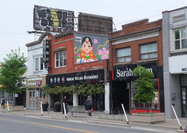 Korean Village Restaurant with mural on upper level,