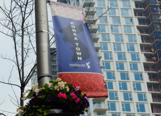 Koreatown banner on lamp post, condos behind