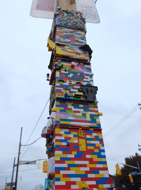 lego tower, looking up towards street sign on the top