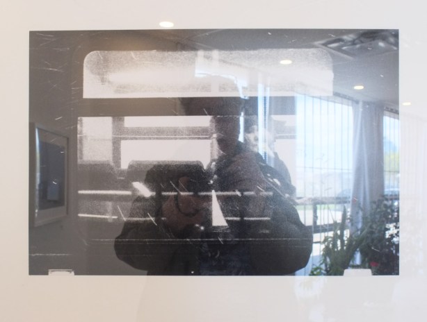 framed black and white photo hanging on a gallery wall