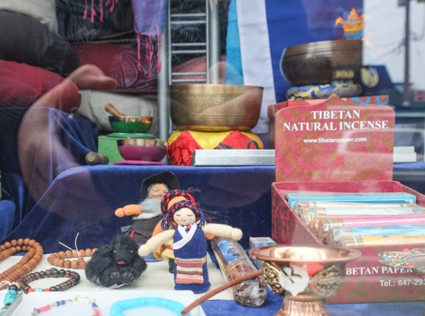 objects in the window of the Tibetan Paper Shop, little dolls, incense, bowls, bracelets,