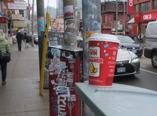 tims cup on a box on the sidewalk in chinatown, 