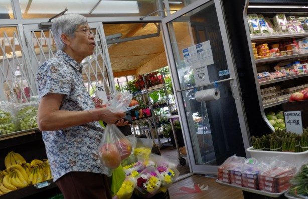 older Korean woman shopping in corner store
