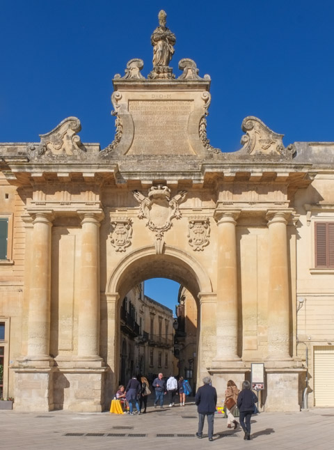 old city gate, with 4 columns and large arched opening, made of stone