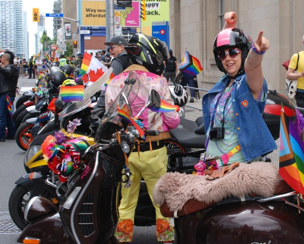 dykes on bikes on motorcycles, pre parade, rainbow flags, canadian flags, 