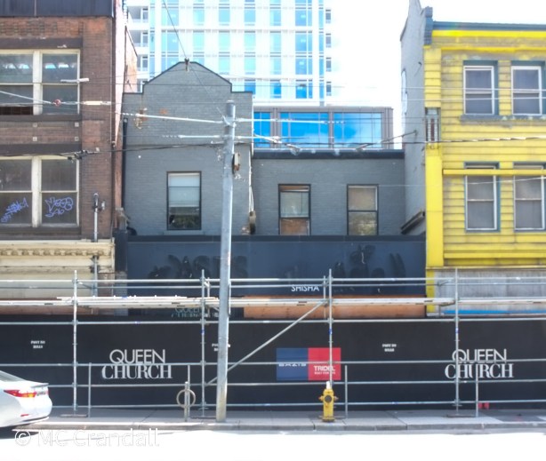 scaffolding and hoardings in front of a few buildings on church street, awaiting demolition and redevelopment