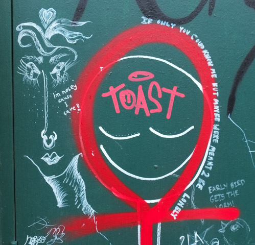 graffiti, words along with red female symbol, about loneliness and being nosey because I care