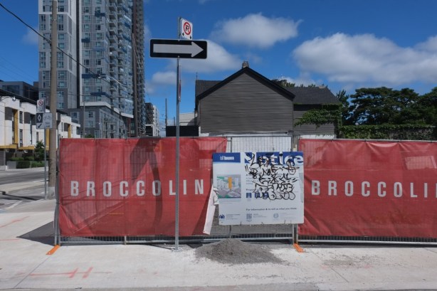 red hoardings around vacant construction site
