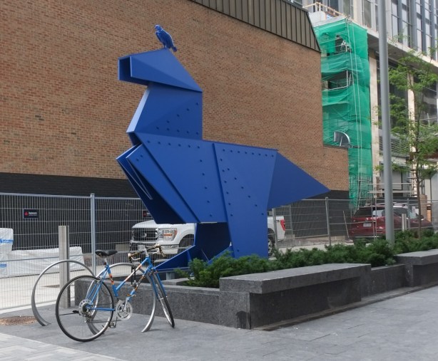 Large blue bird, metal sculpture, title is raptor, by nathan mabry, in yorkville