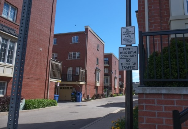 looking down a private road at a townhouse development