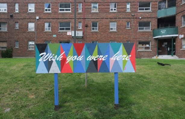 Nigel smith sign, multi coloured, with text wish you were here