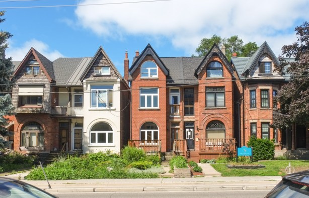 a row of three storey houses on river street, bay and gable style,