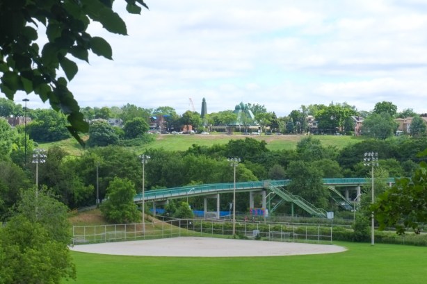 view of Riverdale park with green pedestrian bridge over the DVP and Don River