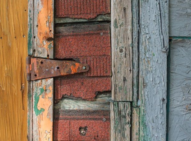 rusty hinge on a gate in an alley