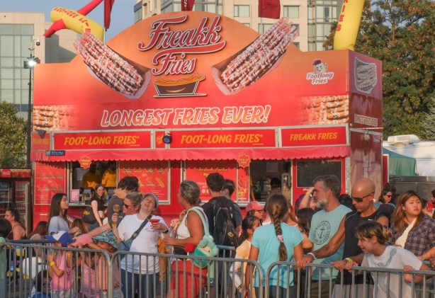 freakk fries food stand at the ex, with a crowd of people in front of it