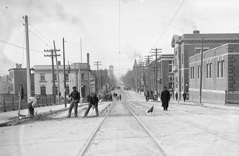 old black and white photo of men working on the queen street bridge over the don river