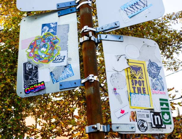 graffiti stickers on the back of street signs