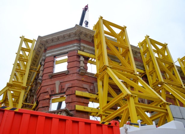 close up of an older brick building that has been gutted, but facade is being retained for redevelopment into metrolinx, ttc, subway station entrance
