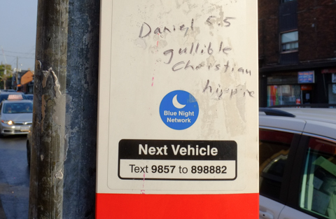 graffiti writing on TTC bus stop pole that says Daniel 5.5 gullible Christian hippie