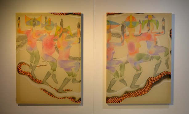 a pair of paintings, Collision Gallery, by R Perera, serpents and people with green legs and feet dancing on them