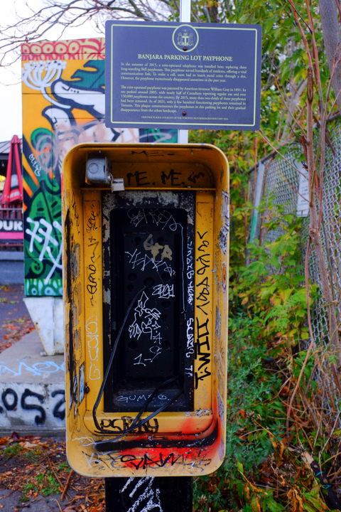 empty small telephone booth with a plaque on top