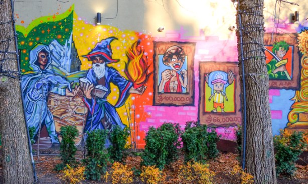 part of a mural on the exterior wall of 401 games, wizard and sorcery, pokemon cards, 