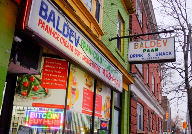 store in Little India, Baldev Paan, light green painted exterior, many signs in window, 