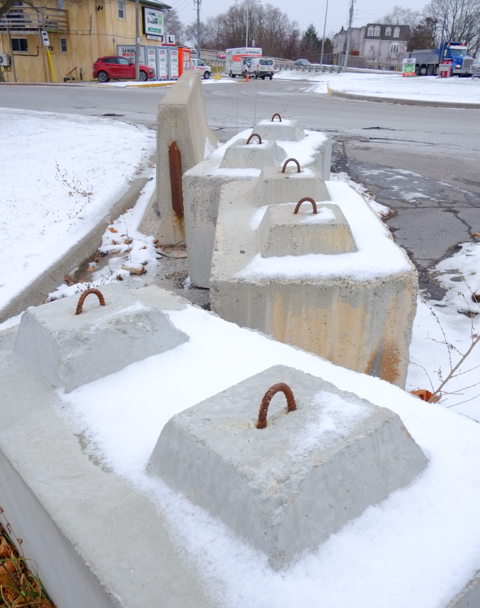 large concrete barriers to block entrance to a parking lot