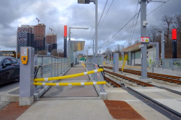 looking east at Sunnybrook Park LRT station on the Eglinton LRT line, no trains running yet but station is somplete, yellow barriers across the entrance