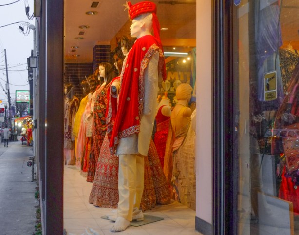 mannequins in a window, evening, yellowish light inside