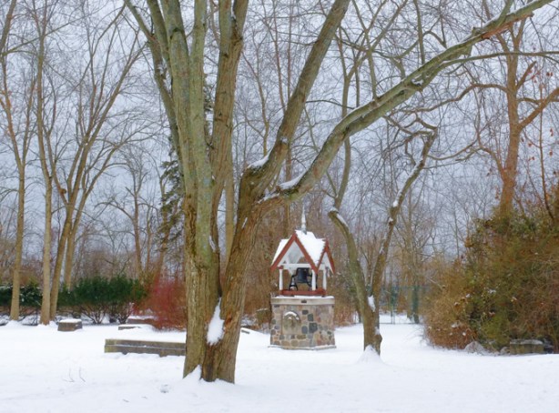 old stone wishing well, in snowy park
