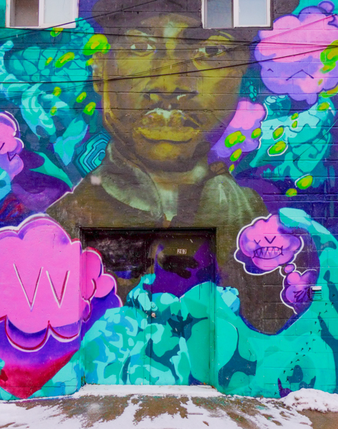 mural on a building in laneway in chinatown, black man, with pink boxing gloves,