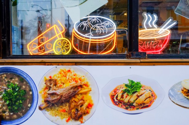 outside wall of a restaurant, pictures of menu items on plates, also lights in the shape of a basket of steamed dumplings, a bowl of ramen noodles, and a drink with a straw and a slice of lemon