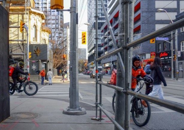 cyclists at the corner of dundas and mutual