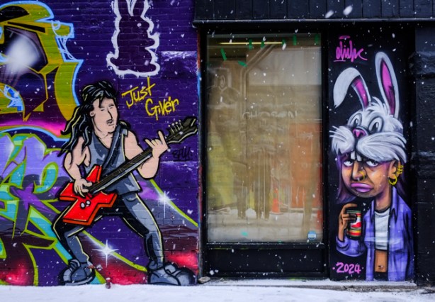 graffiti alley mural, guitar player, red guitar, also an elicser elliott piece of a person wearing a rabbit hat