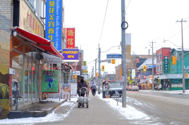 dundas at Jean Lumb Lane, south side, man on sidewalk pushing baby stroller, snow,, winter,